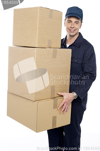 Image of Working man delivering stack of cardboard boxes