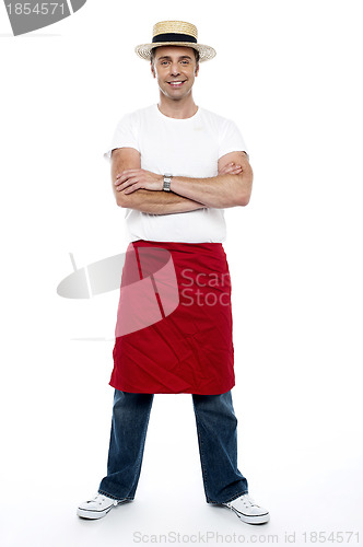Image of Stylish chap wearing hat. Apron tied on his waist