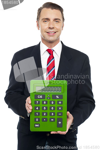 Image of Young businessman showing big green calculator