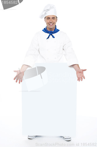 Image of Chef holding blank billboard. Full length shot