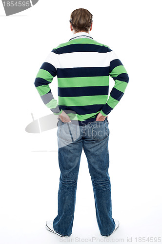 Image of Back pose of man posing with hands in pocket