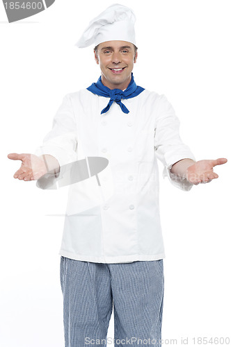 Image of Smiling chef posing with his arms wide open