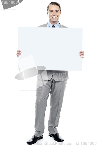 Image of Successful business executive holding blank ad board