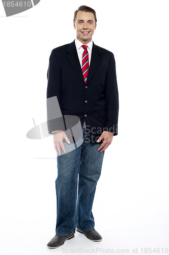 Image of Ful length portrait of young businessman in jeans