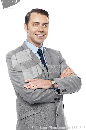 Image of Male consultant smiling with his arms crossed