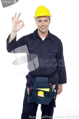 Image of Senior repairman showing good work done sign