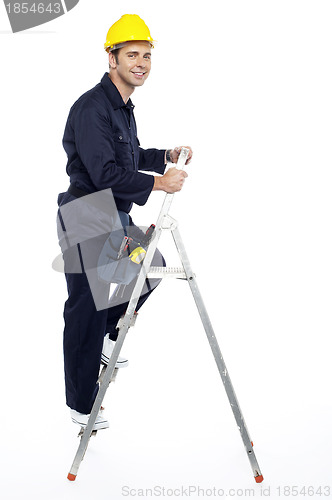 Image of Industrial employee stepping up the ladder