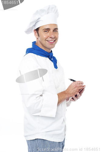Image of Chef taking down the order from customers