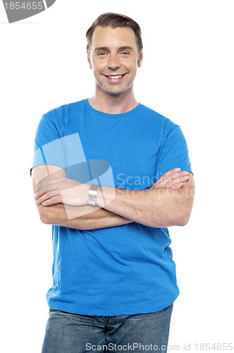 Image of Smart young guy posing with arms crossed