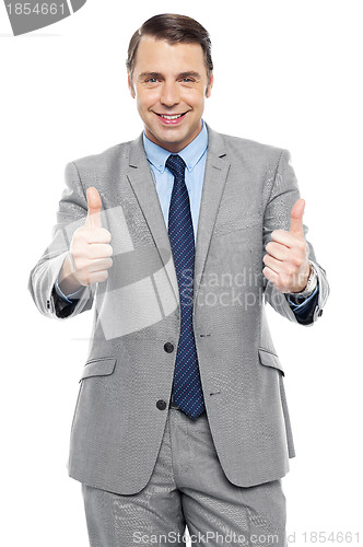 Image of Handsome executive showing double thumbs up