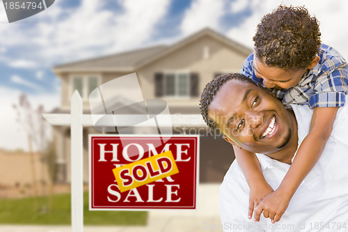 Image of Mixed Race Father and Son In Front of Real Estate Sign and House