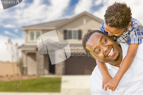 Image of Mixed Race Father and Son In Front of House