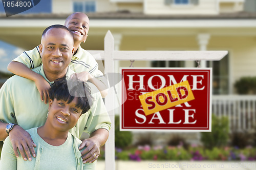 Image of African American Family In Front of Real Estate Sign and House