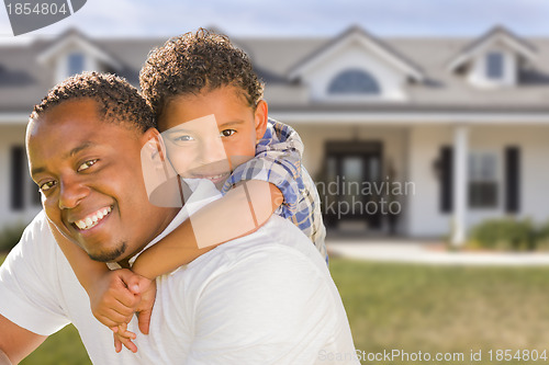 Image of Mixed Race Father and Son In Front of House