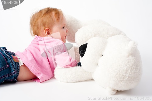 Image of Baby girl with bear toy