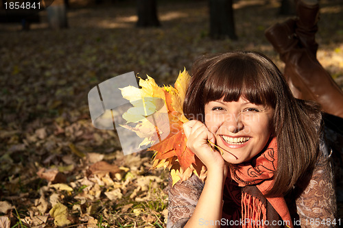 Image of woman with autumn leaves