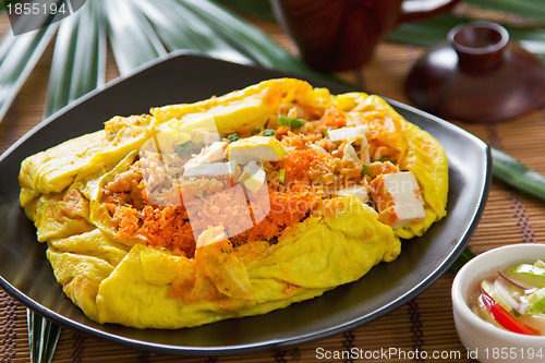 Image of Stir fried vegetables and coconut wrapped in omelet [Thai's food]