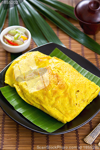 Image of Stir fried vegetables and coconut wrapped in omelet [Thai's food]