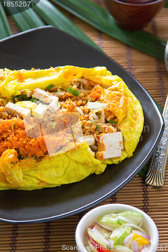 Image of Stir fried vegetables and coconut wrapped in omelet [Thai's food]