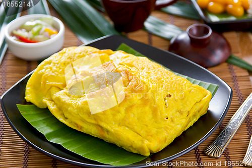 Image of Stir fried vegetables and coconut wrapped in omelet [Thai's food] 