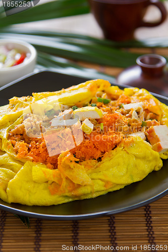 Image of Stir fried vegetables and coconut wrapped in omelet [Thai's food]