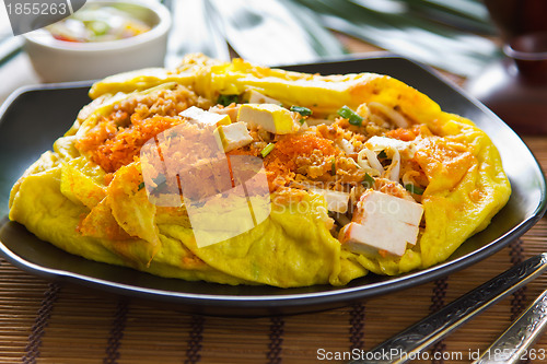 Image of Stir fried vegetables and coconut wrapped in omelet [Thai's food]