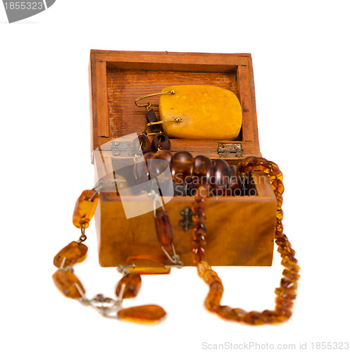 Image of Amber jewelry in retro wooden box isolate on white 
