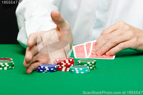 Image of Man with cards on a gambling table