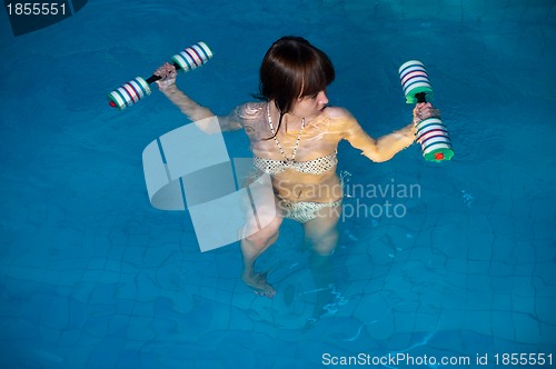 Image of Attractive girl trains in aqua aerobics