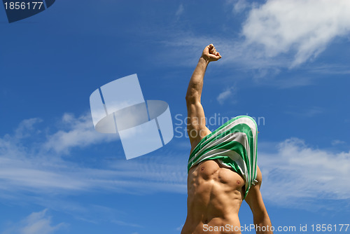 Image of Happy winner with shirt on his head