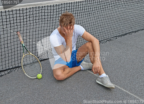 Image of Lost game. Disappointed tennis player.