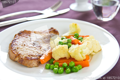 Image of Pork steak with sautéed vegetables