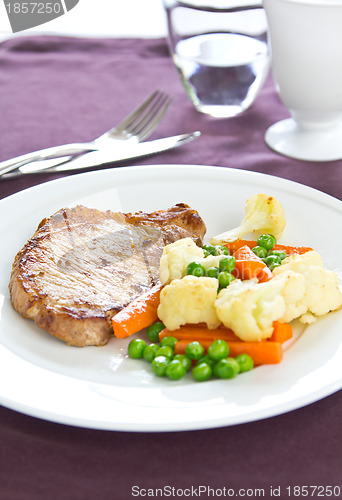 Image of Pork steak with sautéed vegetables