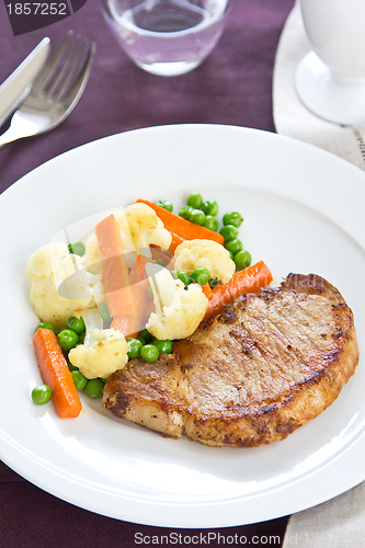 Image of Pork steak with sautéed vegetables