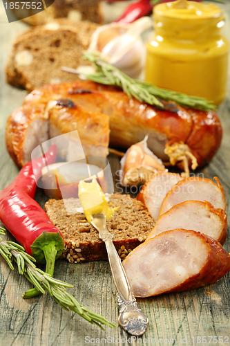 Image of Rye bread with sausage and mustard.