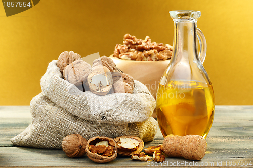 Image of Walnut oil in bottle and nuts.