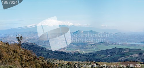 Image of Sicilian rural landscape in winter with snow peak of Etna volcano in Italy