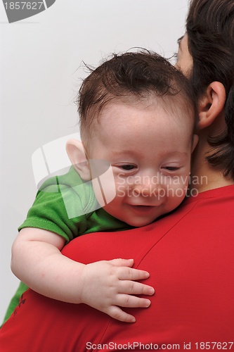 Image of Rear view of cute smiling baby boy  looking over mother  shoulder