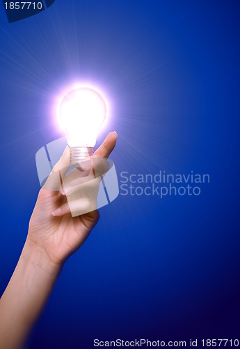 Image of lamp in the woman's hand as a symbol of light