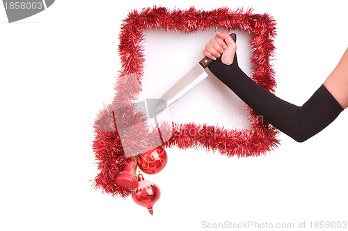 Image of woman's hand with knife in the new-year frame