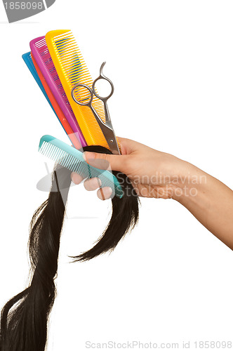 Image of hairdresser cutting young woman