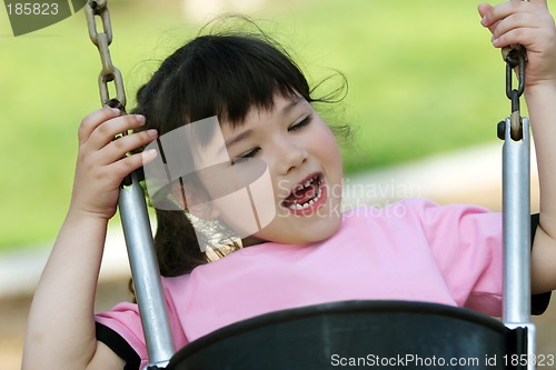 Image of Cute girl swinging