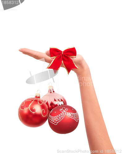 Image of three Christmas-tree balls in the hand