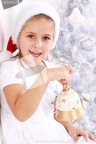 Image of Girl hold Christmas bell