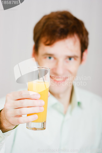 Image of smiling man with a glass juice