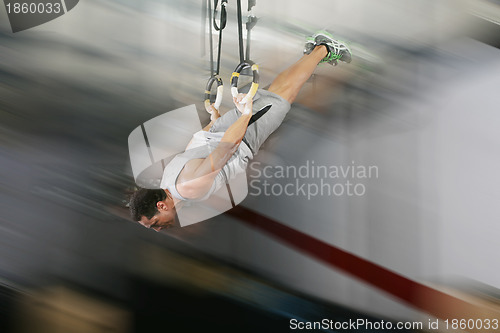 Image of The sportsman the guy, carries out difficult exercise, sports gy