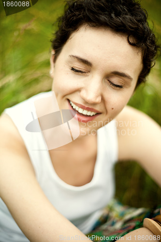 Image of happy cute girl on green field 