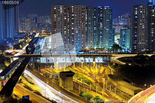 Image of traffic light through city at night