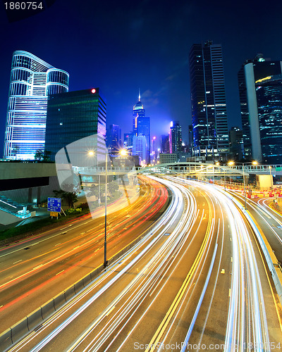 Image of traffic light through city at night