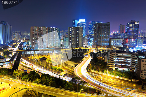 Image of traffic light through city at night